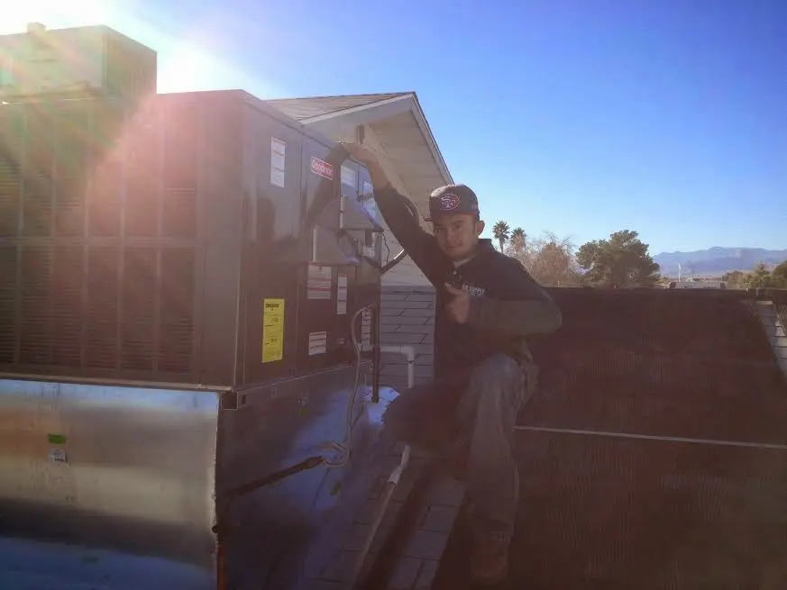 HVAC technician performing AC Tune-Up on a rooftop unit in Egg Harbor